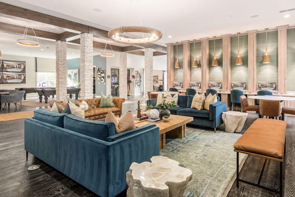 a large living room with blue couches and chairs