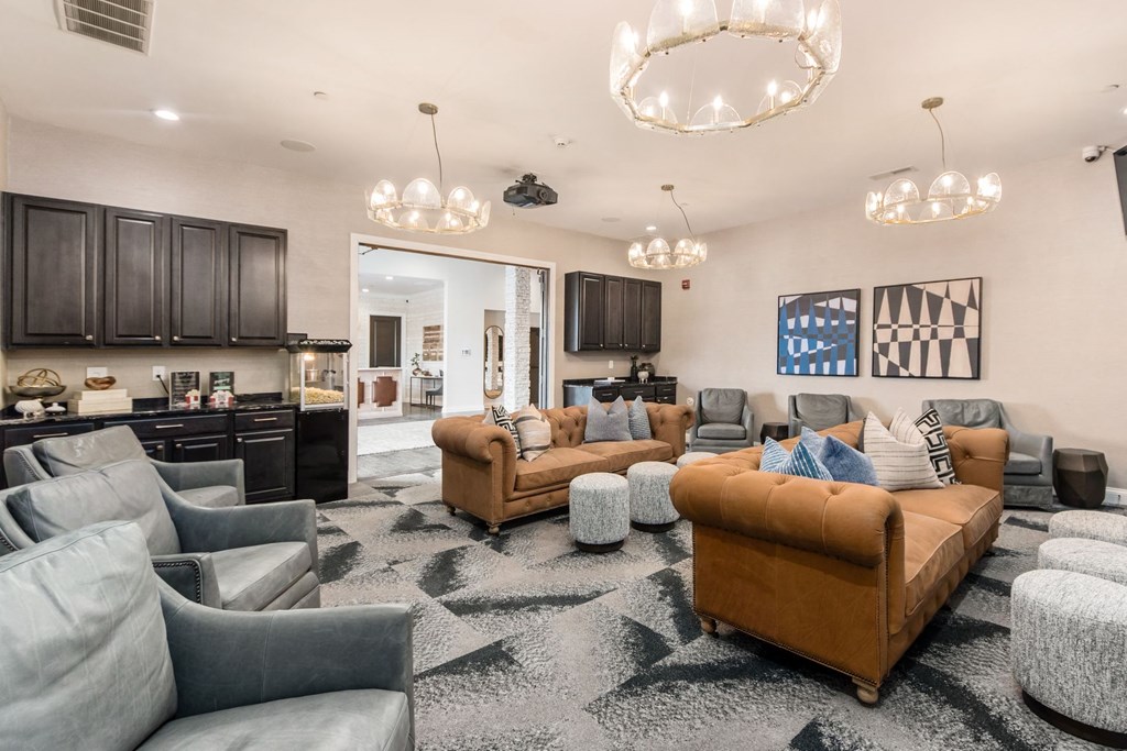 a living room with couches and chairs and a kitchen