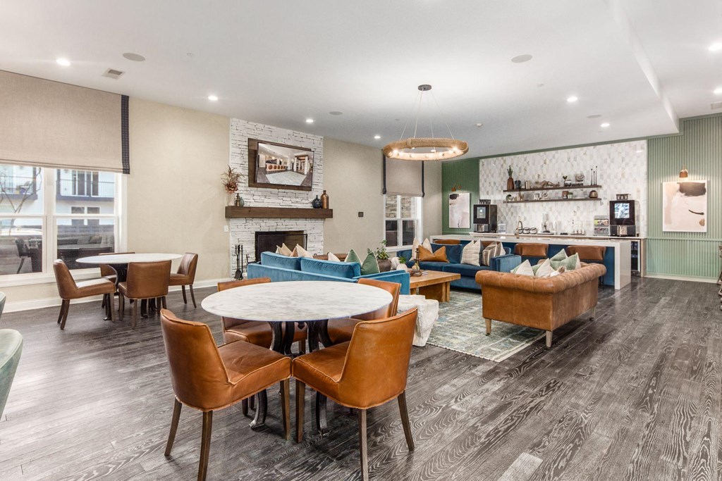 a living room with couches tables and chairs and a fireplace