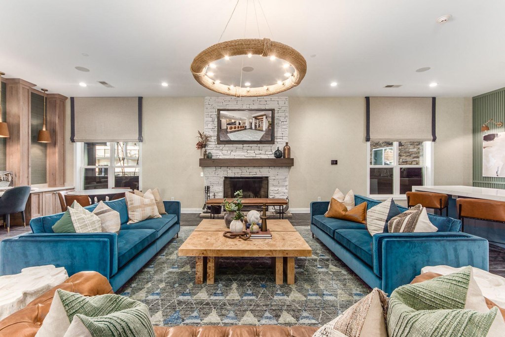 a living room with blue couches and a fireplace