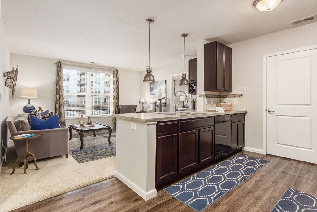 an open kitchen and living room with a couch and a table