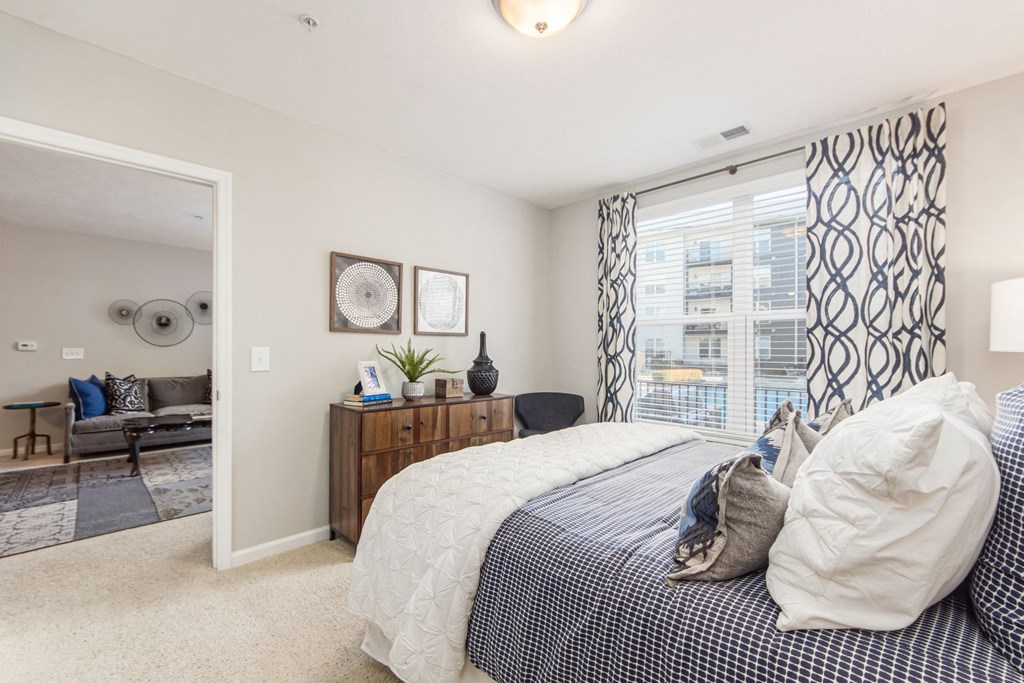 a bedroom with a large window and a bed