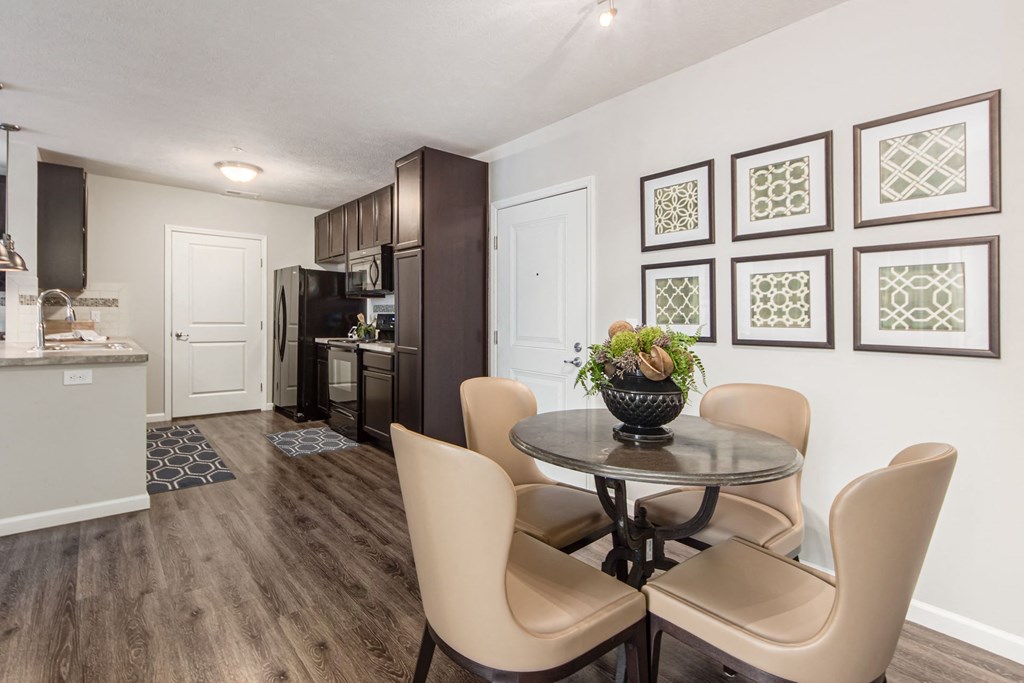 a kitchen and dining room with a table and chairs