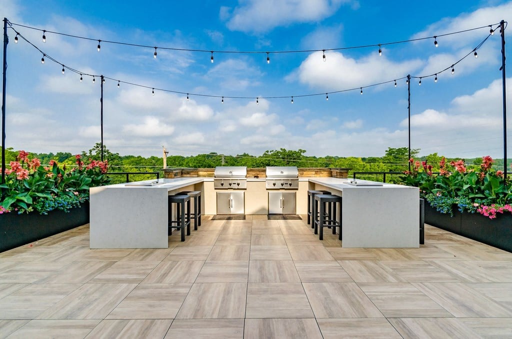 an outdoor kitchen with stainless steel appliances and bar stools