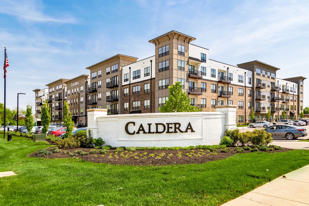 an exterior view of an apartment building with a sign for caldera apartments