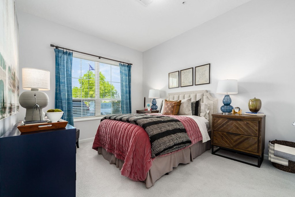 a bedroom with a bed and a large window