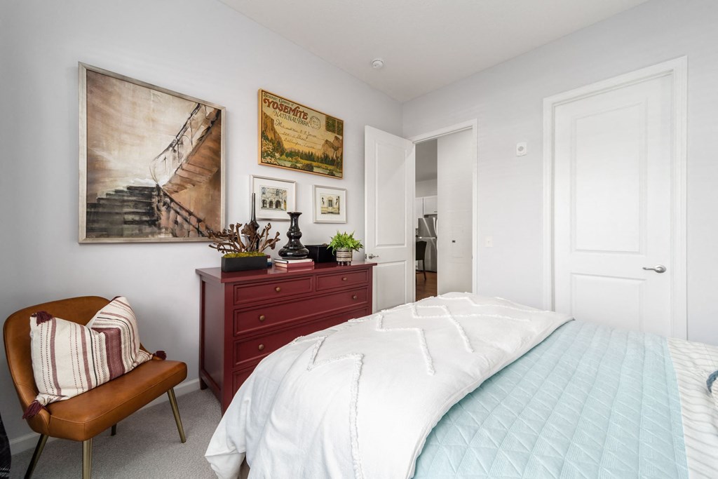 a bedroom with a bed and a dresser