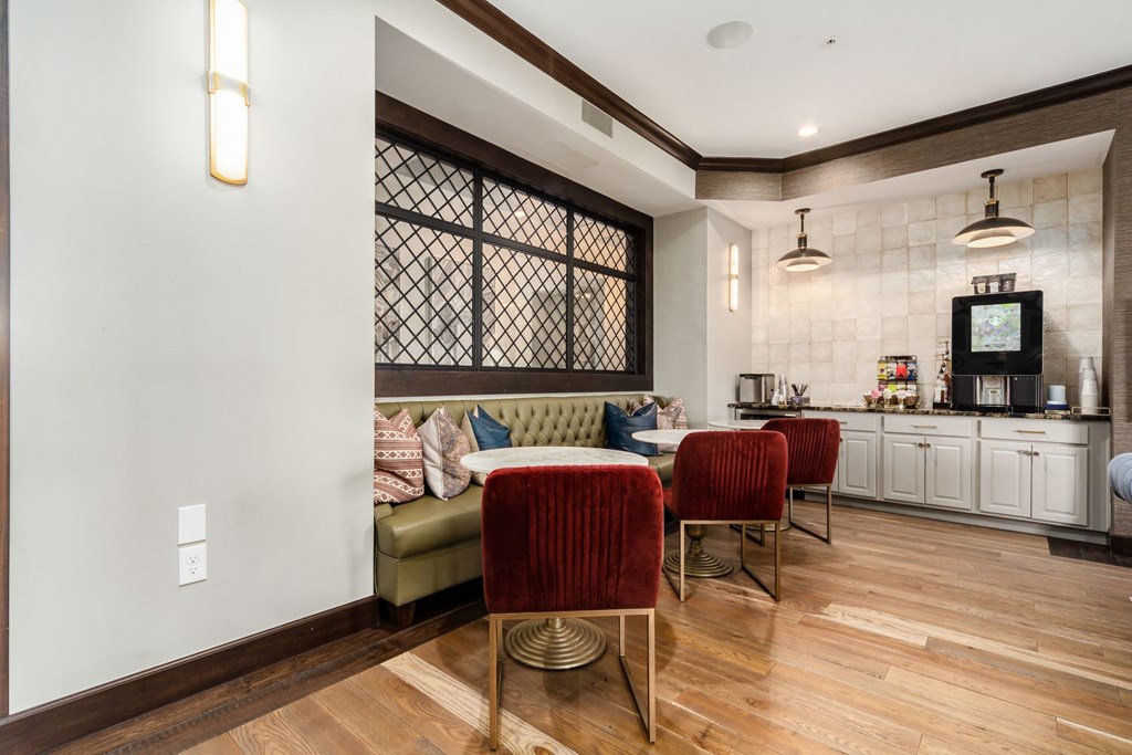 a living room with a couch and a table with chairs
