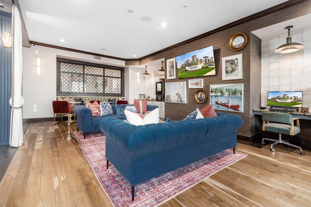 a living room with a blue couch and a rug