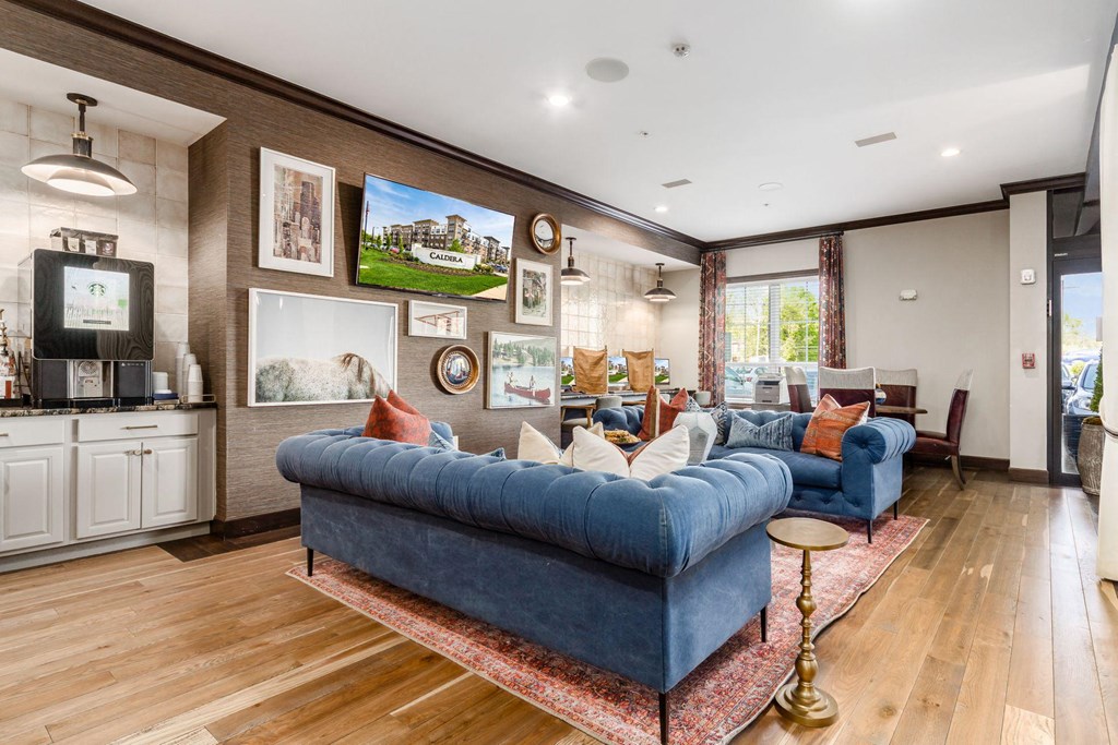 a living room with a blue couch and a tv