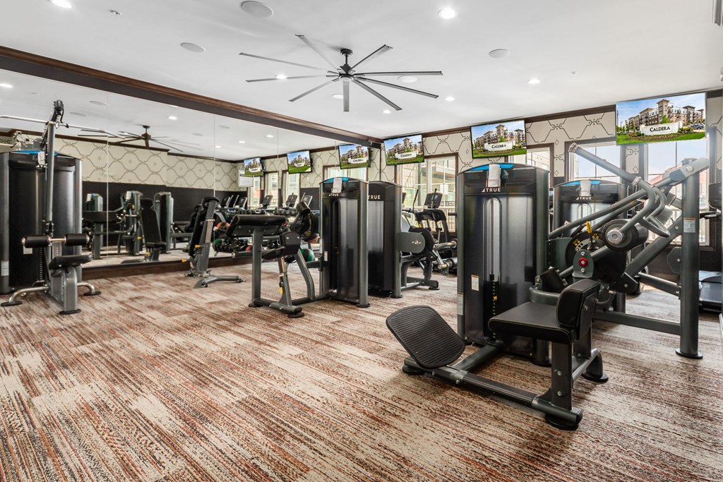 a gym with a lot of machines and weights