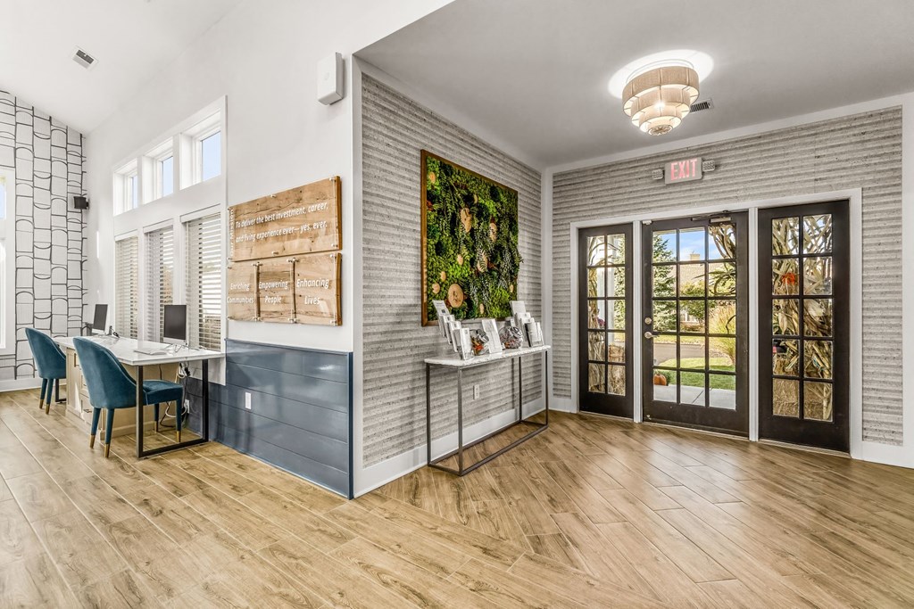 a living room with a desk and a door