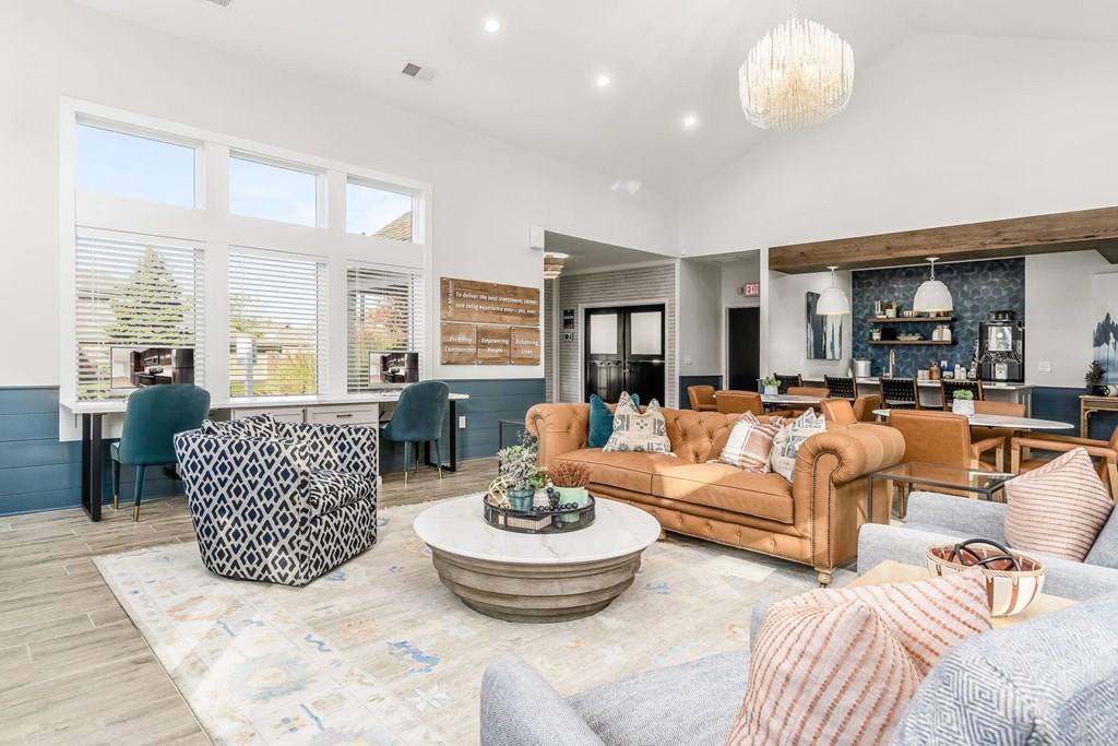 a living room with couches and chairs and a table