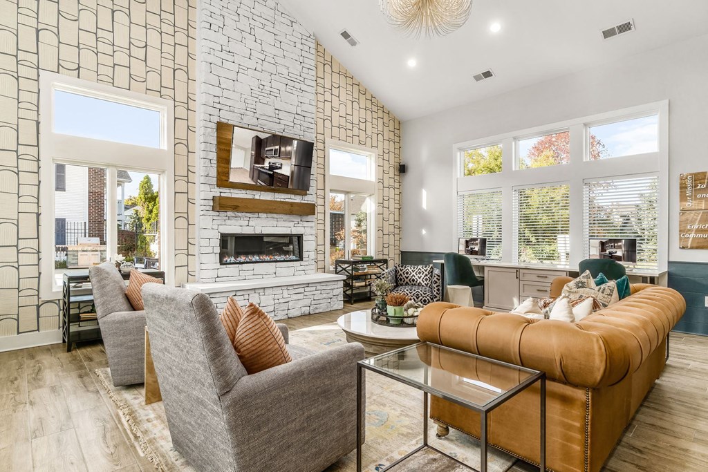 a living room with couches and chairs and a fireplace