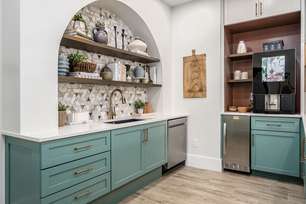 a kitchen with blue cabinets and a sink