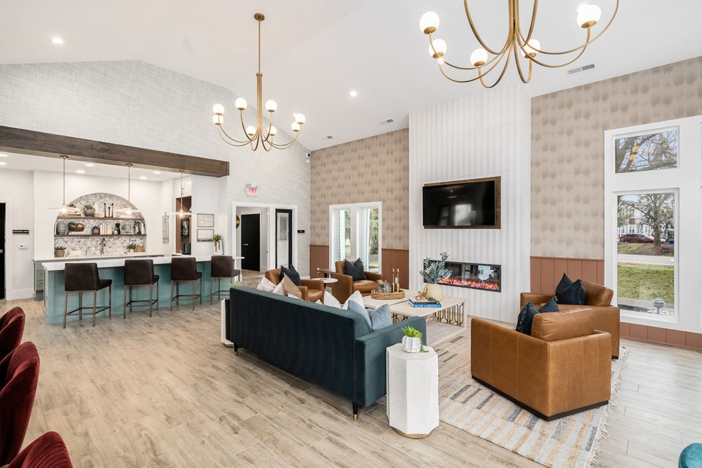a living room with couches and chairs and a fireplace