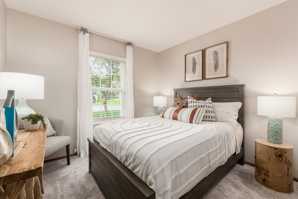 a bedroom with a large bed and a window