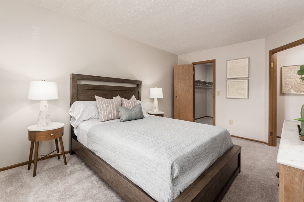 a bedroom with a large bed and a closet