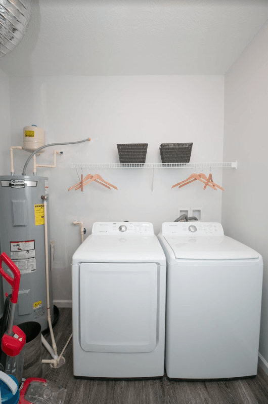 two washers and a dryer in a laundry room
