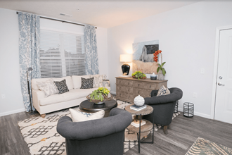 a living room with a couch and two chairs