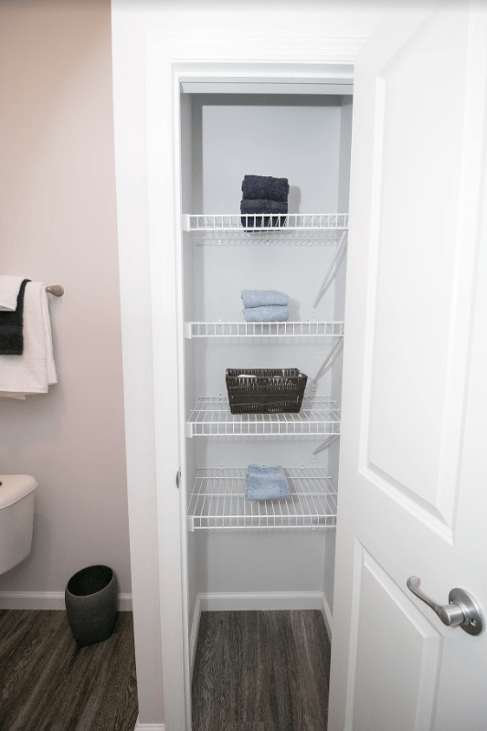 a small bathroom with a closet and a white door