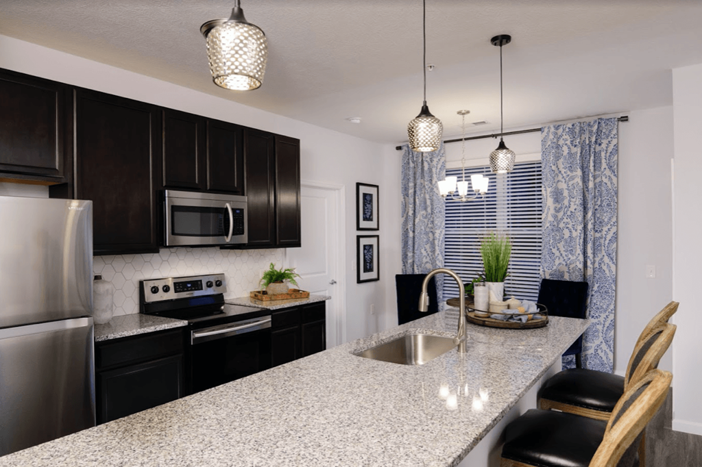 full kitchen with granite countertops and stainless steel appliances at the preserve at great neck