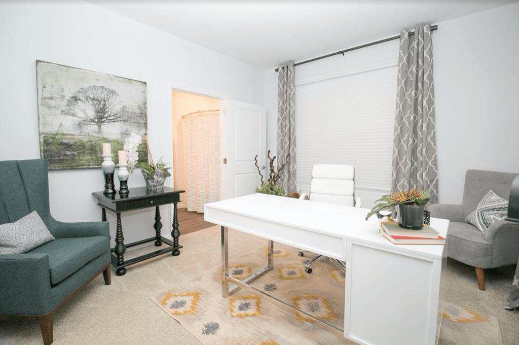 a home office with a white desk and a gray chair