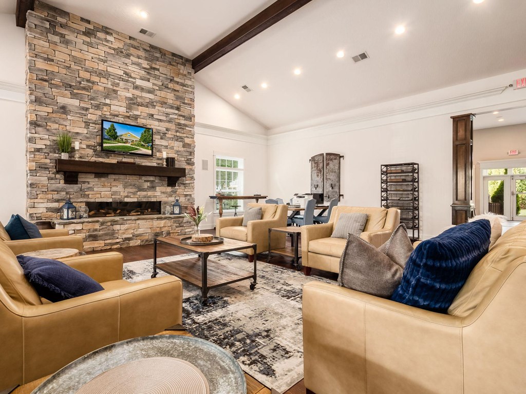 a living room with couches and chairs and a fireplace