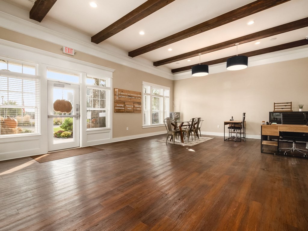 a living room with a hard wood floor and a piano