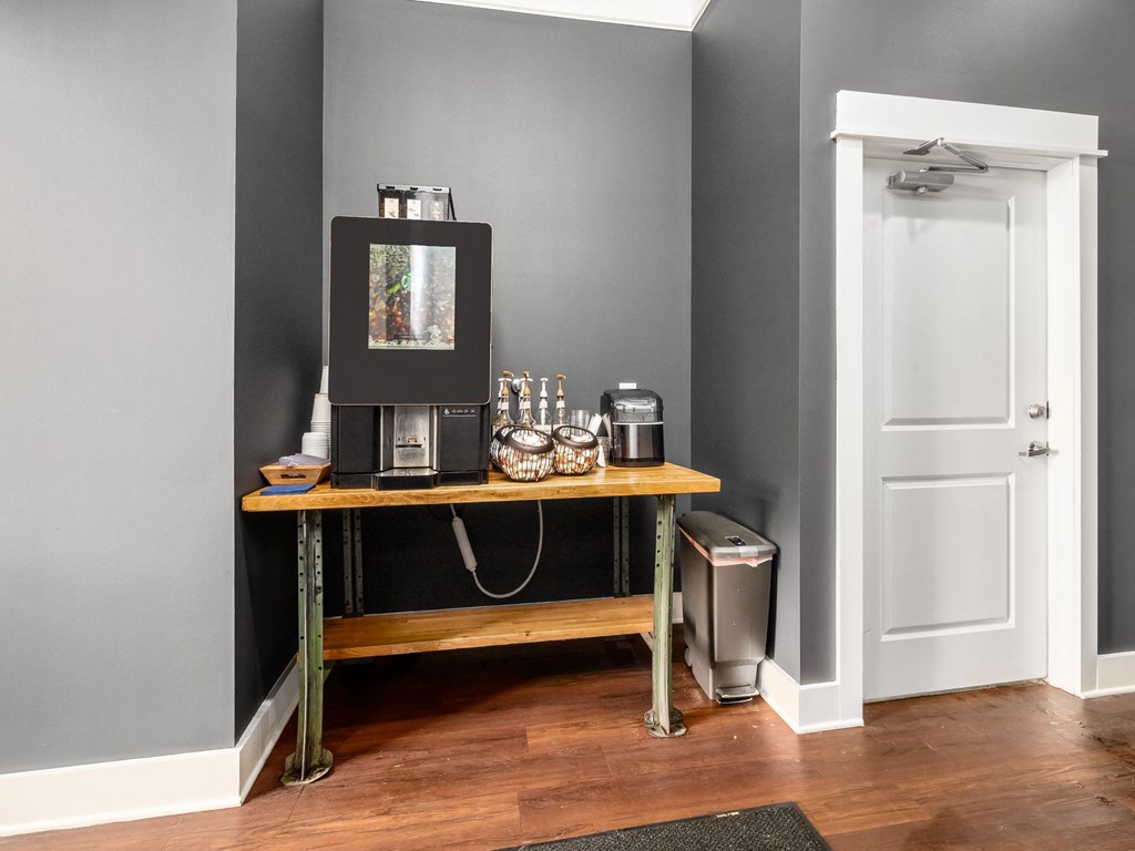 a coffee machine on a table in a room with a door