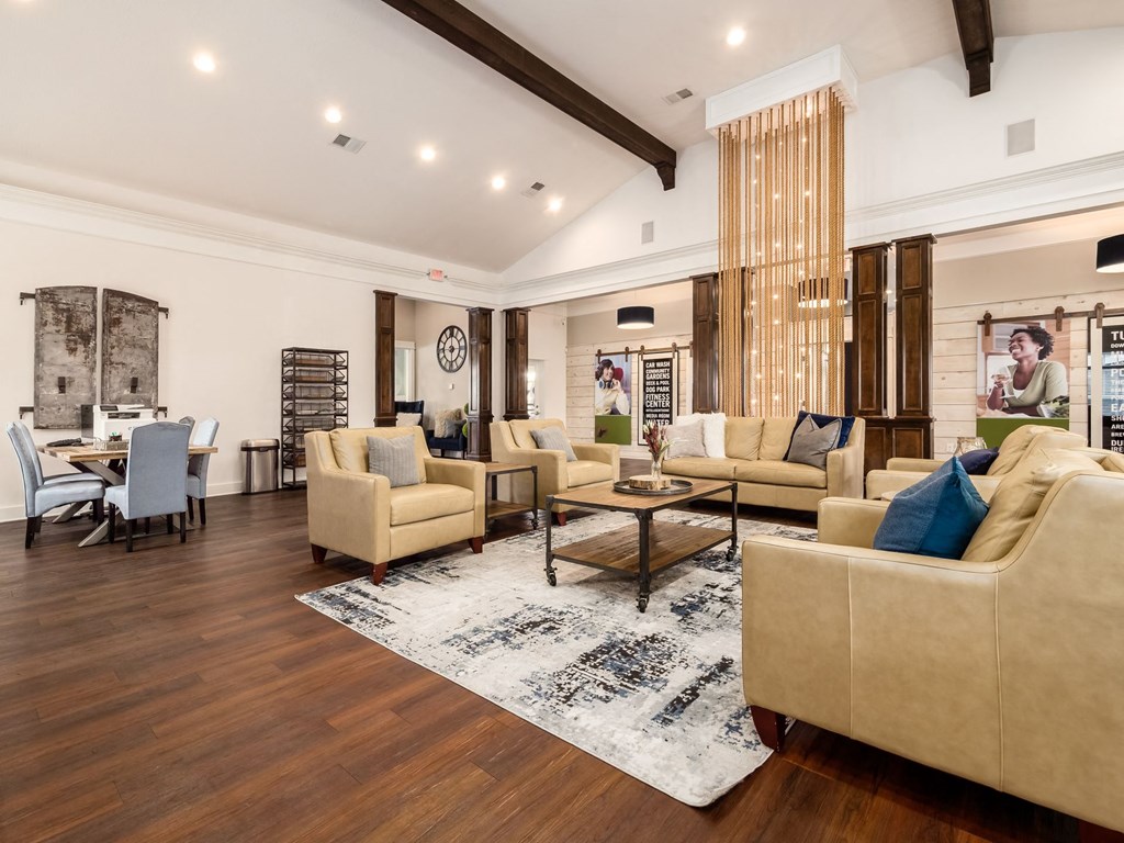 a living room with couches and chairs and a table