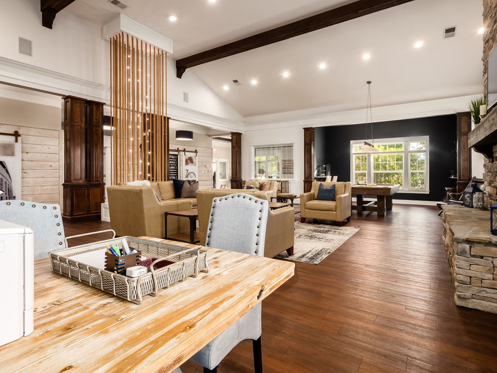 a large living room with a table and chairs and a fireplace