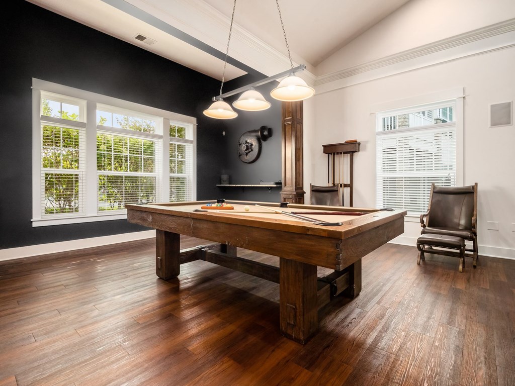 a game room with a pool table and a chair