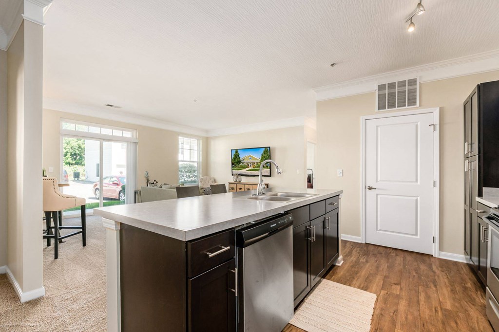 a large kitchen with a counter top and a sink