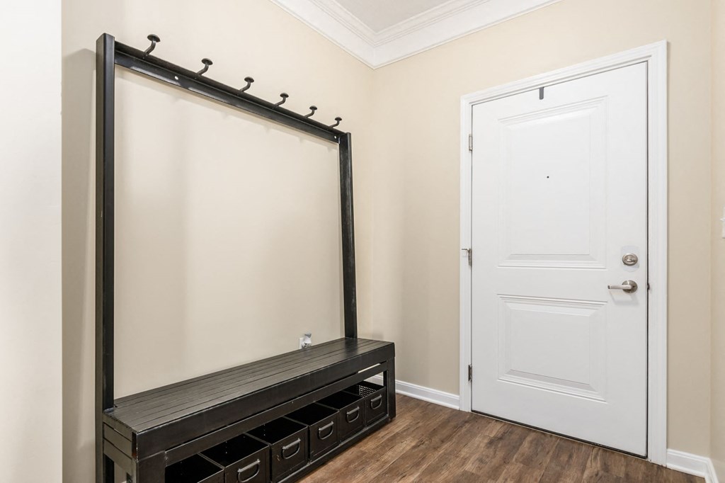 a room with a large mirror and a white door