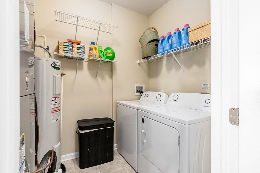 a washer and dryer in a laundry room with a refrigerator