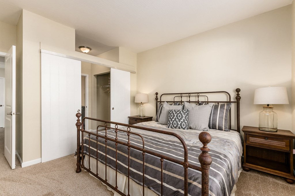 a bedroom with a bed and a door to a bathroom