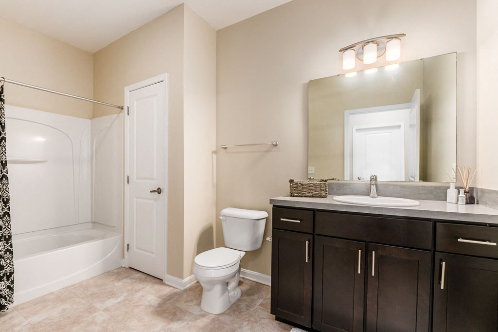 a bathroom with a toilet sink and a mirror