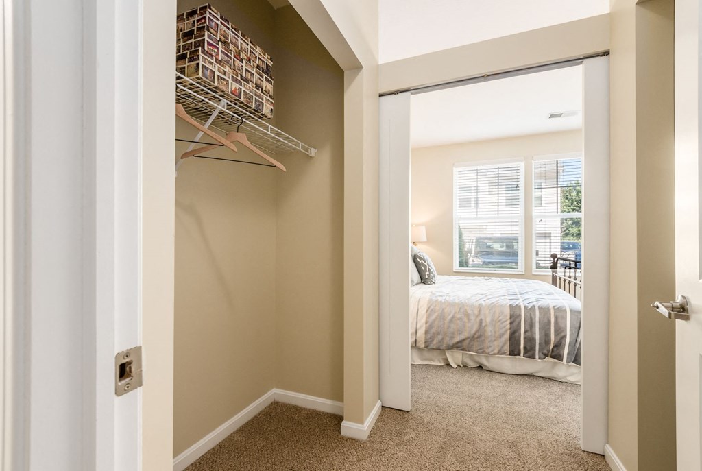 a bedroom with a closet and a bed and a window