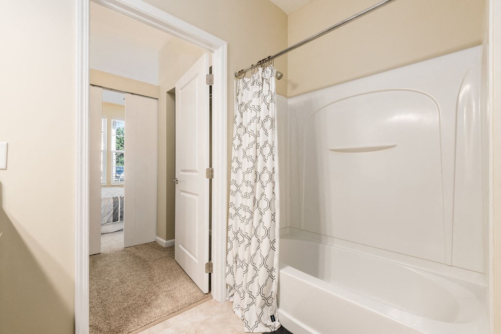 a bathroom with a shower and a bath tub