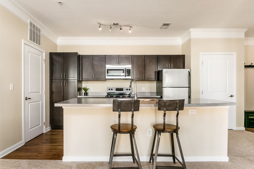 a kitchen with a island and two bar stools