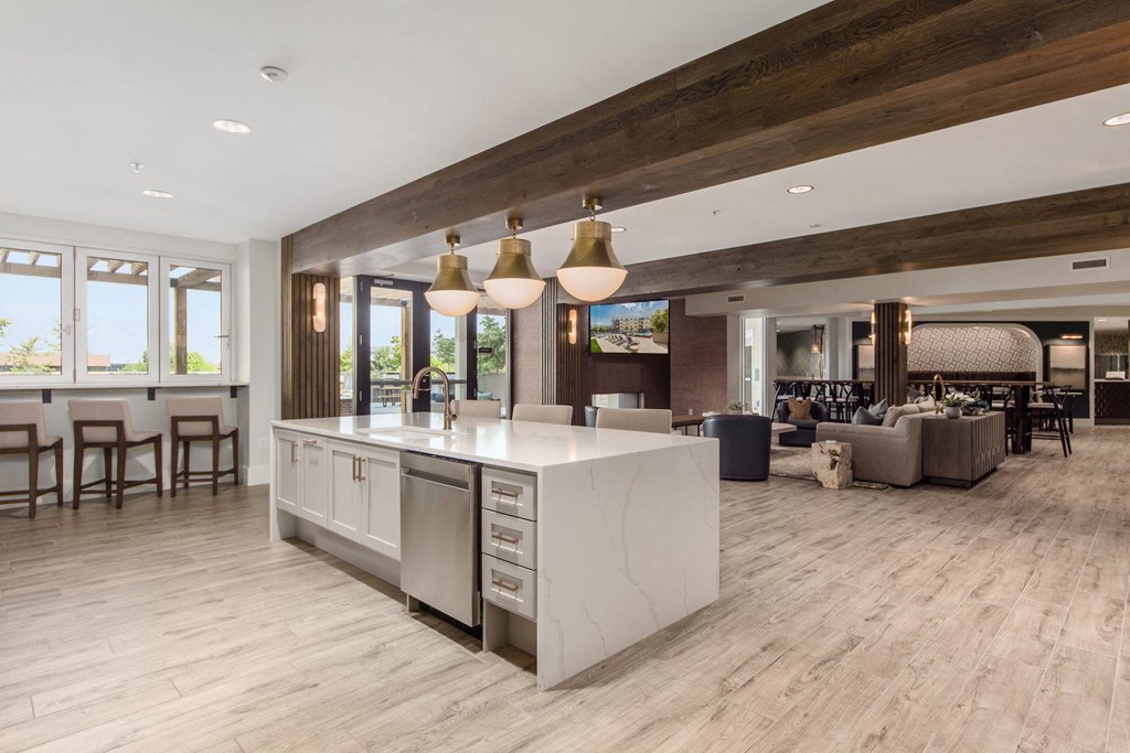 a large kitchen with a center island and a living room