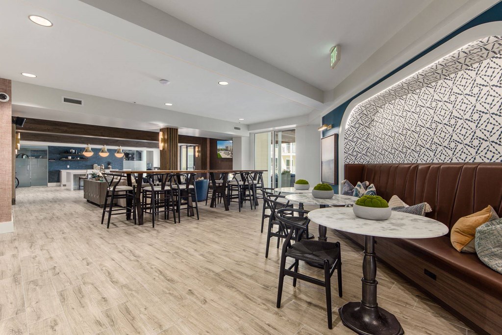 a dining room with tables and chairs and a bar