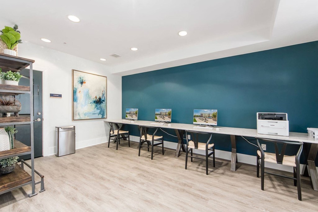 a conference room with a long table with chairs and a printer