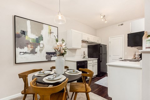 a dining room and kitchen with a table and chairs