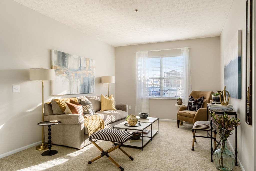 a living room with a couch and a chair and a table