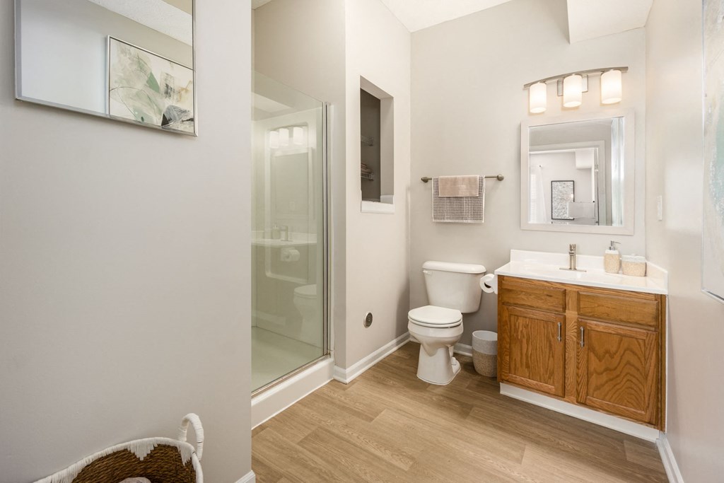 a bathroom with a toilet and a shower and a sink
