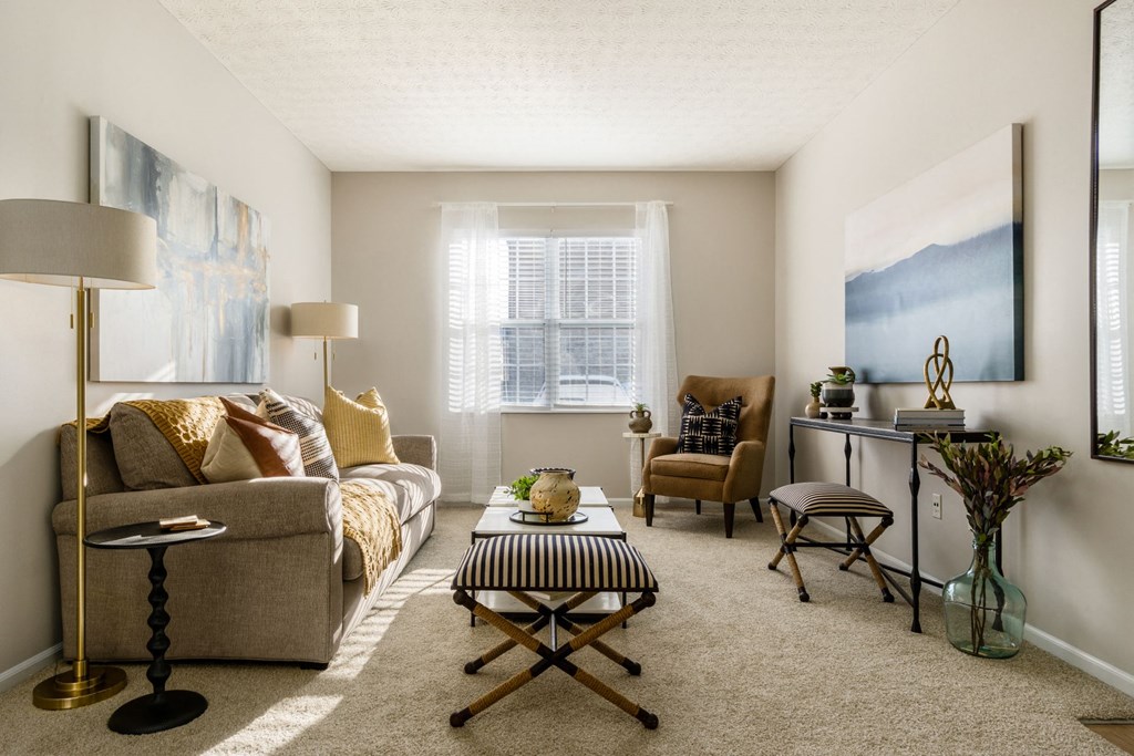 a living room with a couch and chairs and a table