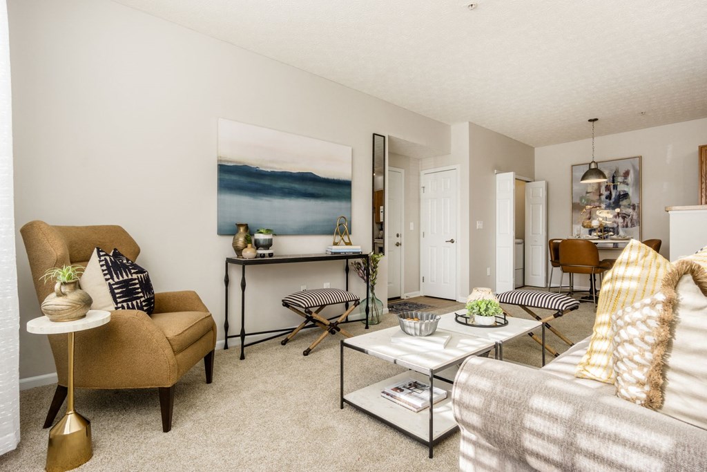 a living room with a couch and chairs and a table