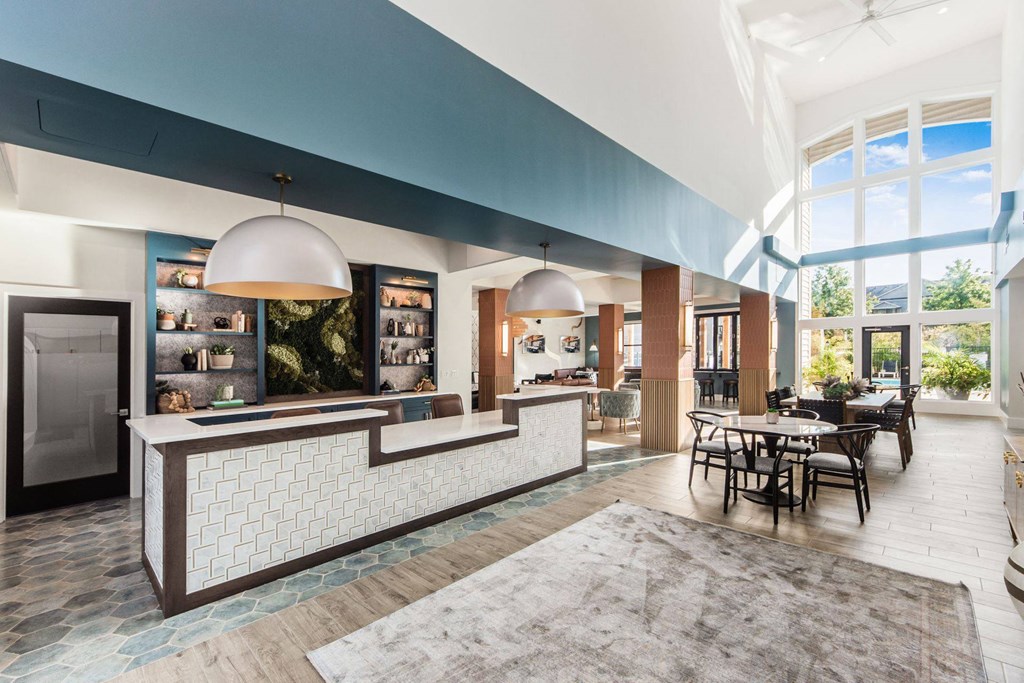a lobby with a reception desk and a table with chairs